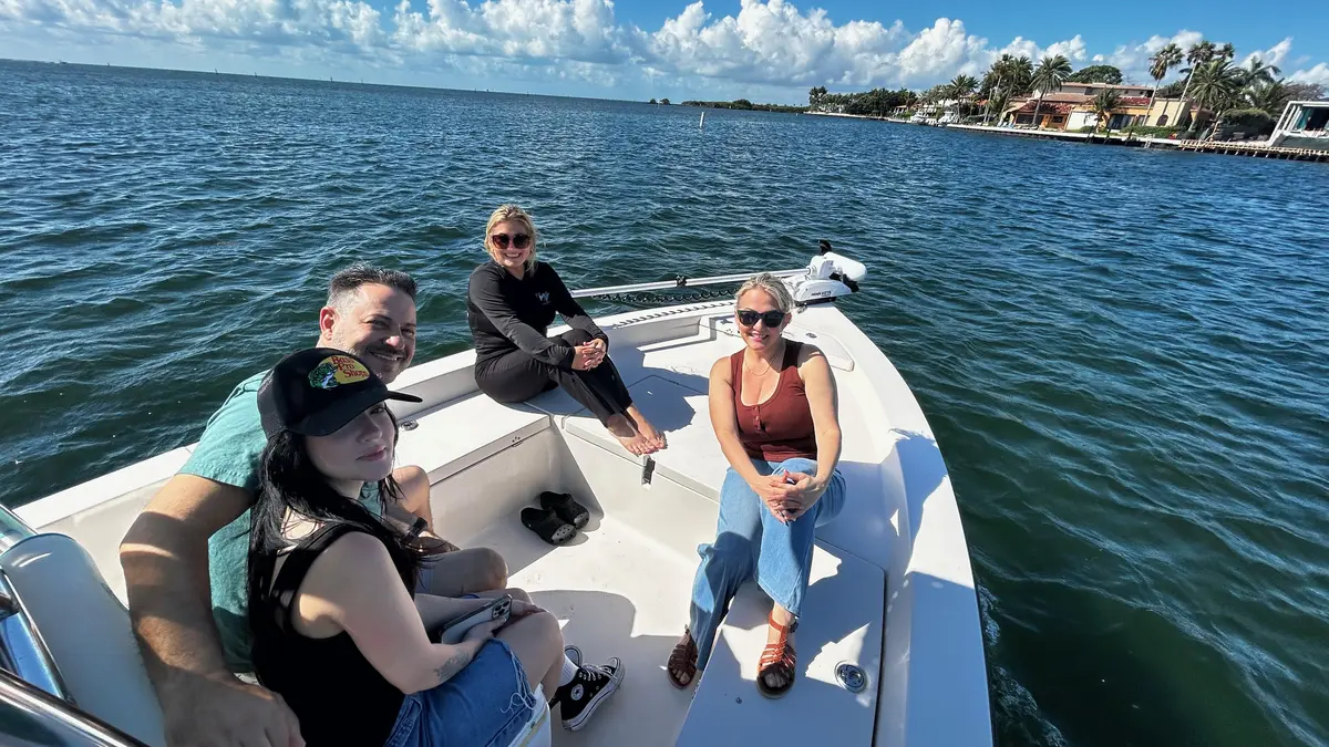 Happy group of guests enjoying a family fishing charter on Biscayne Bay Miami